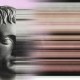 An image showing a marble statue of a man on the left, transitioning with a stoic edge into a distorted, pixelated region, followed by part of a man's face on the right.